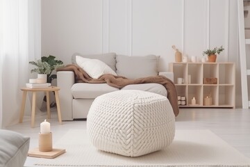 Fototapeta na wymiar White sofa with plaid and cushions on knitted rug on wall background. modern living room. Mockup living room