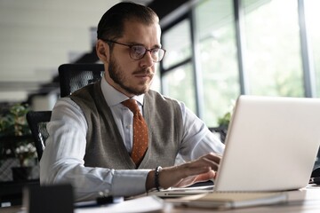 Modern Office Businessman Working on Computer. Portrait of Successful Middle-aged IT Software Engineer Working on Laptop