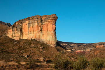 large tall cliff with sunlight on it; Brandwag Buttress impressive sandstone formations rock 
cliff...