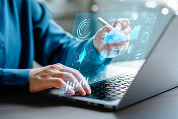 Businesswomen analyze chart data business on a visual screen dashboard laptop, technology devices and screens visible in the background, financial planning, market research, and the stock market.