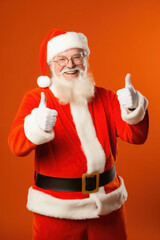Fototapeta na wymiar Portrait of happy man in santa claus costume showing thumbs up on orange background