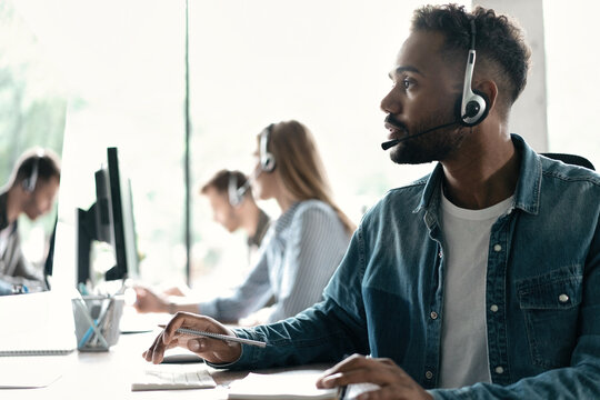 Happy young male customer support executive working in office