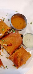 Mysore Masala Dosa filled with spiced potato masala, accompanied by Coconut chutney and sambar, Traditional Indian cuisine which is popular in South India widely eaten as breakfast in Karnataka