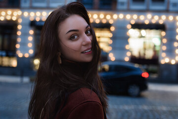 Portrait of a beautiful brunette woman walk in the city at night