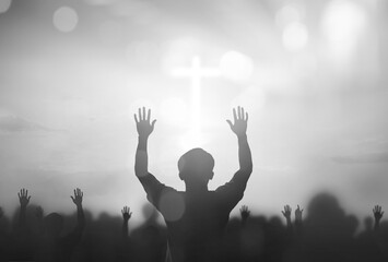 Silhouette human raising hand to praying God on blurred white cross with  bokeh background
