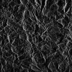 Wrinkled plastic wrap texture on a black background wallpaper. Royalty high-quality free stock photo image of realistic plastic wrap for overlay, copy space and photo effect. Wrinkled plastic surface