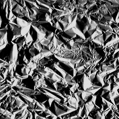 Wrinkled plastic wrap texture on a black background wallpaper. Royalty high-quality free stock photo image of realistic plastic wrap for overlay, copy space and photo effect. Wrinkled plastic surface