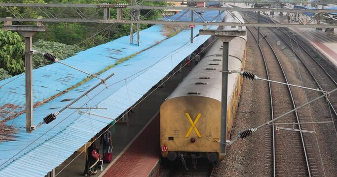 A view of the train roofs in India moving along the Indian railway tracks.