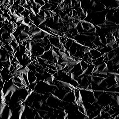 Wrinkled plastic wrap texture on a black background wallpaper. Royalty high-quality free stock photo image of realistic plastic wrap for overlay, copy space and photo effect. Wrinkled plastic surface