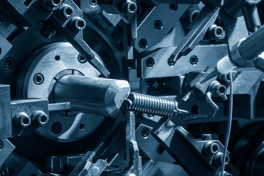 Close up the coil spring machine in light blue scene.