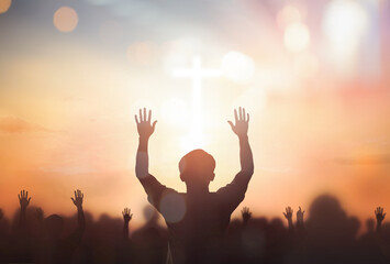 Silhouette christian reaching hands over blurred cross sunset background - obrazy, fototapety, plakaty