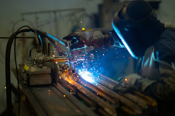 Male welder in steel welding factory.