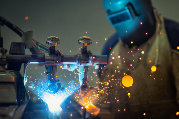 Male welder in steel welding factory.