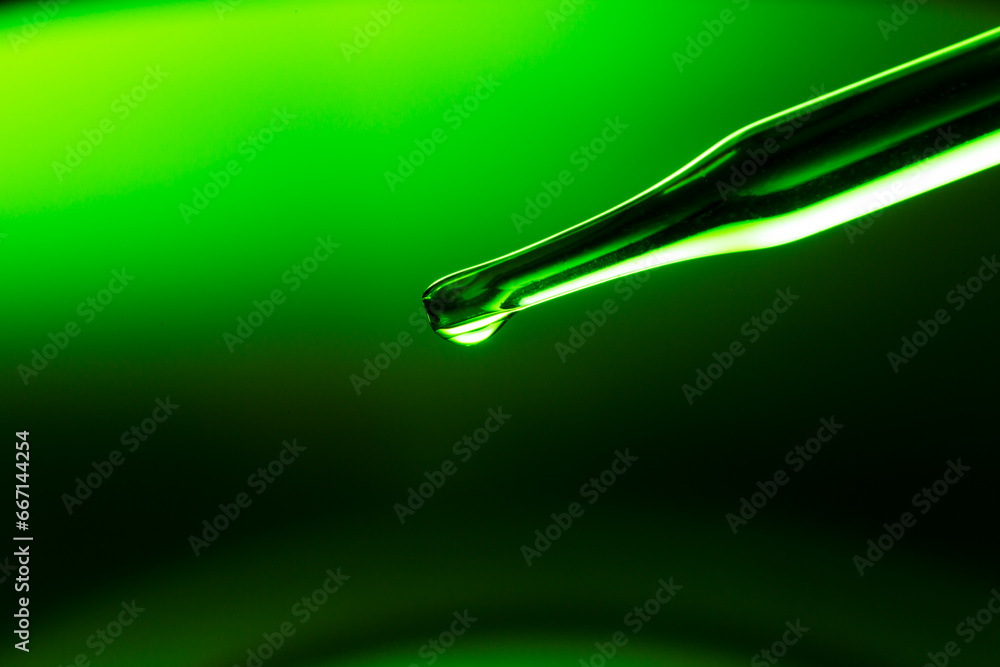 Wall mural macro green science experiment background,lab glassware filled with clear transparent liquids on ref