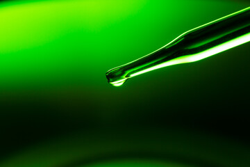 Macro green science experiment background,Lab glassware filled with clear transparent liquids on...