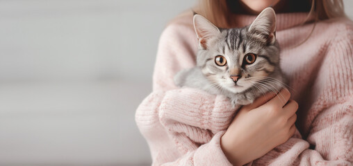 Girl holding little cute kitten. Pet adoption and love to animals concept. banner with place for text - obrazy, fototapety, plakaty