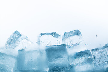 ice isolated white background,Natural crystal clear melting ice cubes on white reflective surface background.