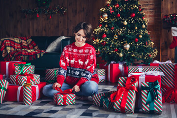 Photo of lovely young lady open giftbox enjoy morning dressed stylish red sweater christmas tree decorated interior living room