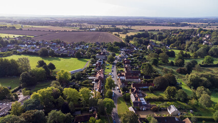 Aerial view of Great Milton. Looking up the village road to show houses and fields. Trees separate...