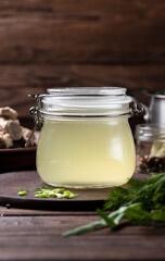 bone broth in a storage jar with herbs