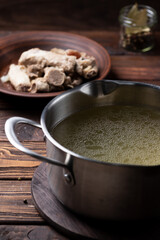 Boiled fatty broth in a saucepan