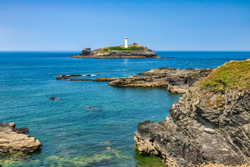 Obraz premium Godrevy Lighthouse, near St Ives, Cornwall, UK, on a bright summer day.