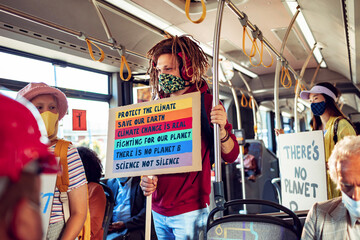 Diverse group of environmentalist going to a protest in the city on a bus