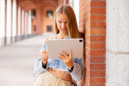 Teenage girl using tablet computer