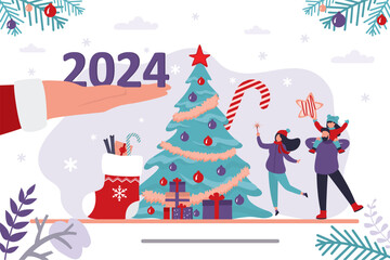 Santa Claus hand gives 2024 year numbers. Happy family near traditional xmas tree, christmas celebration. New year,
