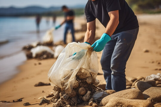 Volunteer collecting garbage on the beach. Recycling concept
