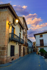 Quaint houses with lit street lamps in a white village of Almeria, Velez Rubio, Spain.
