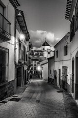 Picturesque white village at dusk in Andalusia, Velez Rubio, black and white photo.