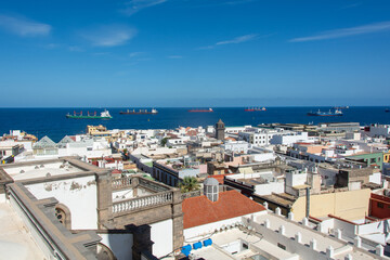 Obraz premium Town with part of the Santa Ana Cathedral, sea and freighter in Las Palmas on Gran Canaria, Spain