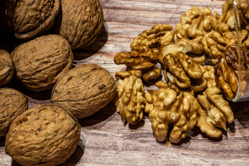 Peeled and whole walnuts coming out of a sack on a table