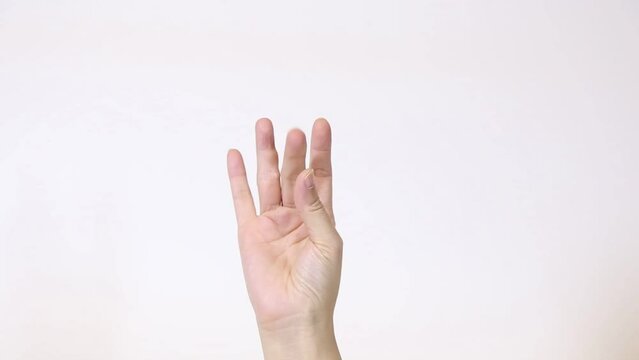 Close-up of woman hand with performing brain stimulating hand exercise on white background