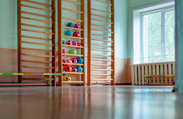Empty sport gym with ladder for children climbing and benches on wooden floor in recreation...