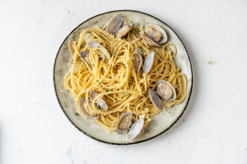 pasta with vongole clams and parmesan in a plate, light background. View from above. spaghetti with seafood