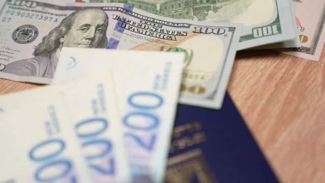 Israeli passport and shekels. Travel passport and dollars. Slow motion. concept: buying tickets from Israel to the USA, travel. Preparing for the trip.