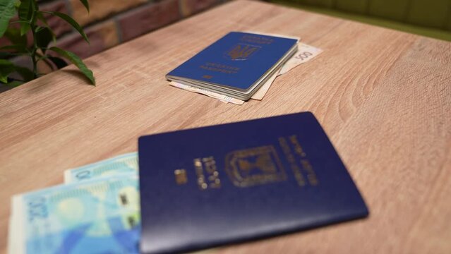 Passport of a citizen of Israel and passport of a citizen of Ukraine, repatriation, aliyah. Paper bills, new Israeli shekel and hryvnia. Absorption basket. Assistance under the Law of Return.
