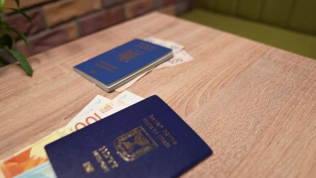 Passport of a citizen of Israel and passport of a citizen of Ukraine, repatriation, aliyah. Paper bills, new Israeli shekel and hryvnia. Absorption basket. Assistance under the Law of Return.