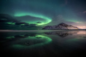 Fototapeten aurora borealis at flakstad beach, lofoten, norway © Remo Peer