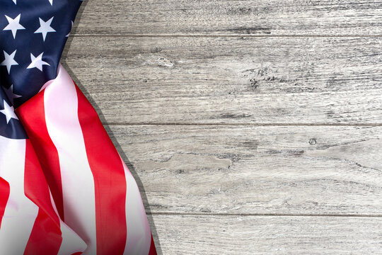 Labor Day, Veterans Day, American flag on a wooden table. 3D illustration.