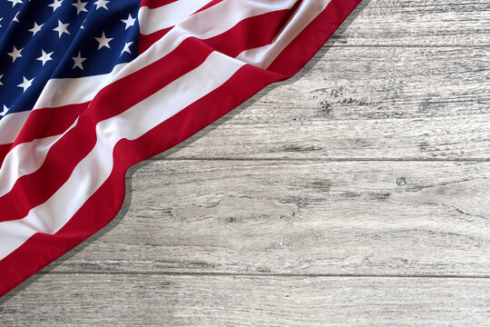 Labor Day, Veterans Day, American flag on a wooden table. 3D illustration.