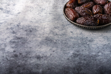 Dates in an iron plate on a dark background. Top view with space for text.