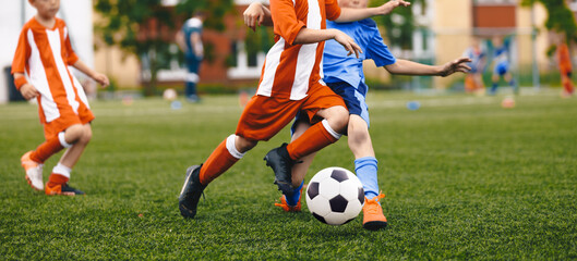 Soccer Boys Kicking Classic Ball in League Match. Children Compete in Team Sports GameYouth Players...
