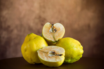 Ripe natural autumn quince on wooden table.
