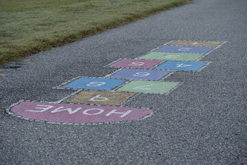 Brightly colored hopscotch squares in a public playground 