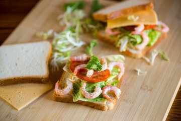 sandwich with lettuce and shrimp.