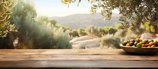 Obraz premium Empty old wooden board table copy space with olive trees in background, use for product display. 