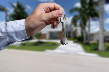 Man hand holding on finger keys to new house.